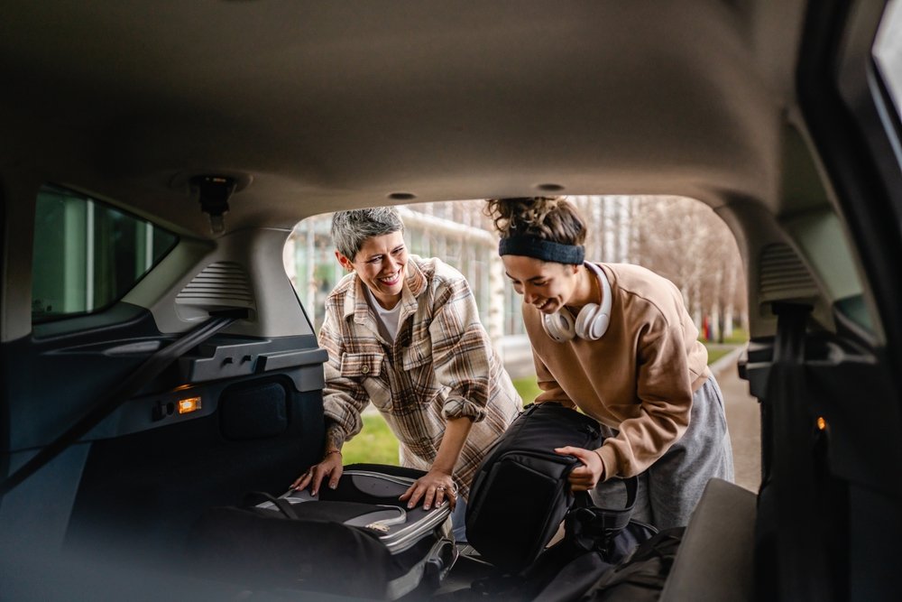 Mother helping college student daughter unload car during move-in, illustrating need for renters insurance in Louisiana.